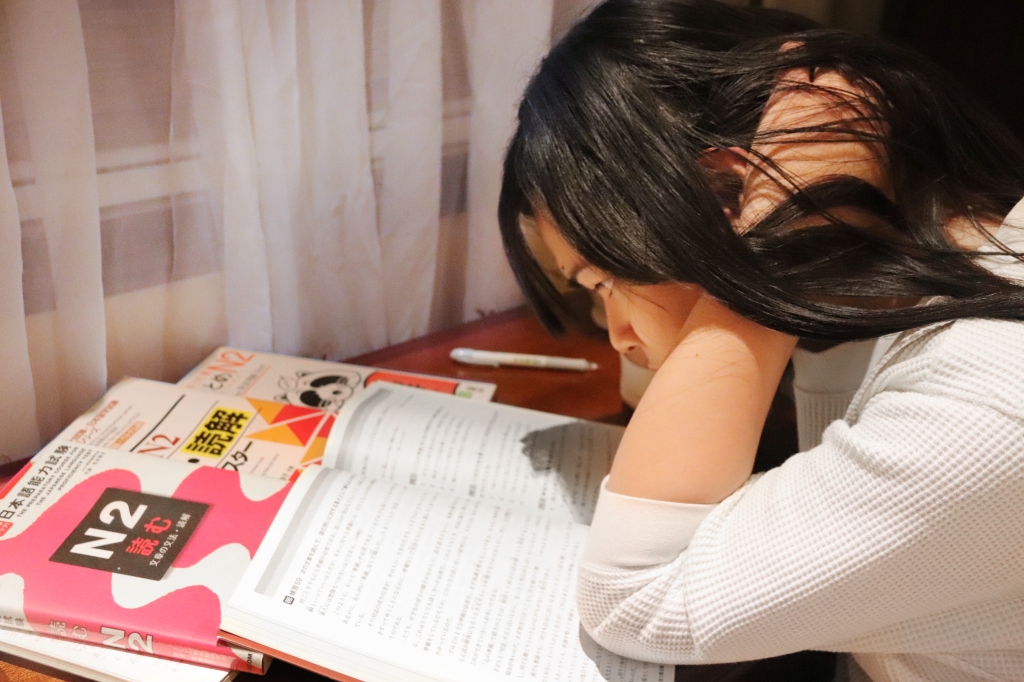 Girl distressed while reading books for study